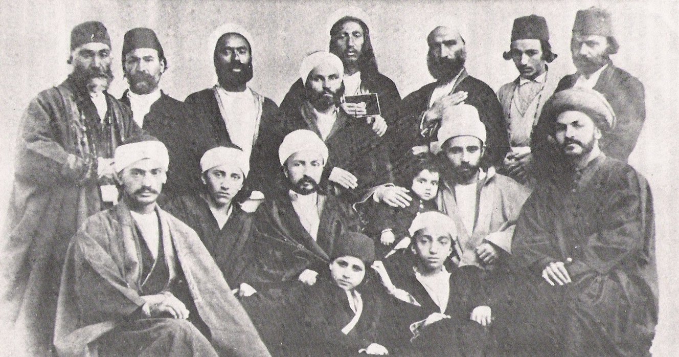 Потомки и последователи Бахауллы в Адрианополе (около 1868 года): (стоят слева направо): Мирза Мухаммад Али Нахри (отец жены Абдул-Баха Муниры Ханум), Мирза Насруллах Тафриши, Набиль-и-Азам, Мирза Ага Джан Кашани (Хадимулла)* (секретарь Бахауллы), Мишкин-Калам, Мирза Али Сайях, Ага Хусейн Ашчи, Ага Абдул Гаффар Исфахани. (Сидят слева направо): Мирза Мухаммад Джавад Газвини*, Мирза Михди (сын Бахауллы), Абдул-Баха (старший сын Бахауллы), Мирза Мухаммад-Кули (младший сводный брат Бахауллы, предположительно, с одним из его детей) и Сиййид Михди Дахаджи (Исмулла Махди)*. (Сидят на земле слева направо): Мадждеддин бен Мусса Ирани* (племянник Бахауллы) и Мирза Мухаммад Али* (сын Бахауллы). Звёздочкой (*) отмечены ставшие последователями унитарного бахаизма